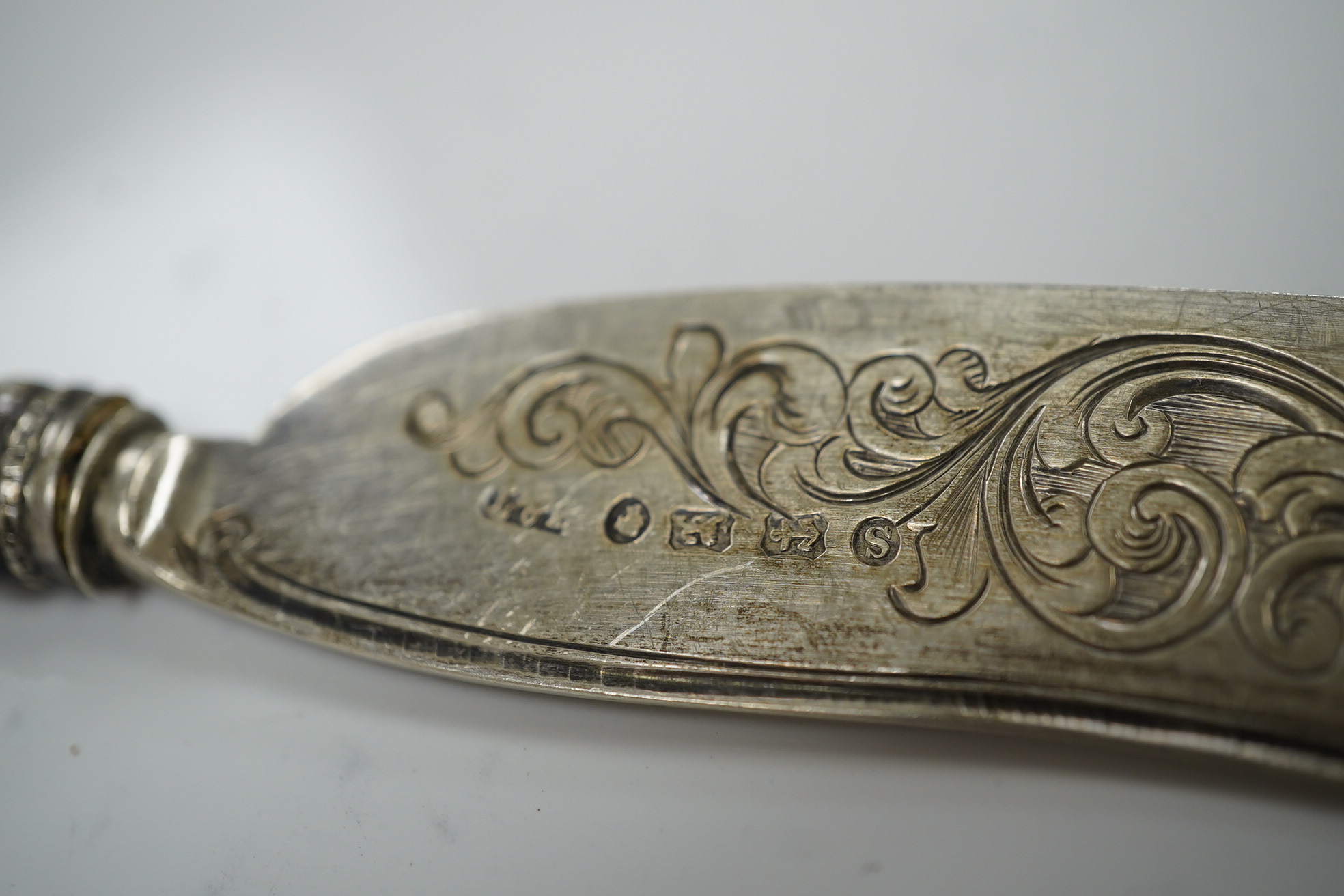 Two Victorian mother of pearl handled butter knives and a Victorian Scottish silver fiddle pattern basting spoon. Condition - fair